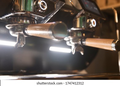 Close Up On A Coffee Cup Filled By The Coffee Machine Of A Bar. No People Are Visible. Low Key Image.