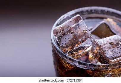 Close Up On A Cold Refreshing Soft Drink With Ice On A Black Background