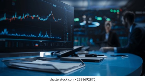 Close Up on a Computer Screen with Real-Time Stock Market Analytics, Graphs and Reports. Stock Exchange Software Template. Brokers Discussing Financial and Business Opportunities in the Background