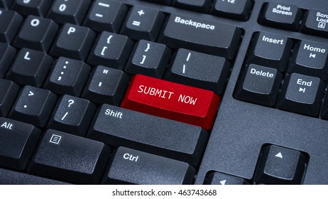Close up on customized computer enter button on keyboard with a word submit now.