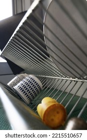 Close Up On Dishes Drying On A Metal Rack. Focus On A Small Glass. Strong Tilt Shift Effect, Perspective Effect.