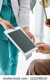 Close Up On Doctor And Senior Patient Hands Holding Digital Tablet With Blank Screen