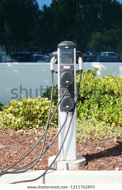 close up on electric vehicle charger station in the\
parking area