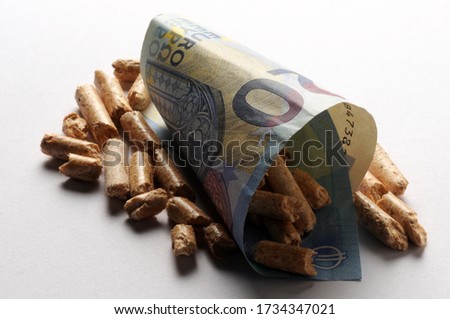 Close up on Euro banknote and wood pellets