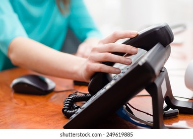 Close Up On Female Hand Holding Phone At Office Desk