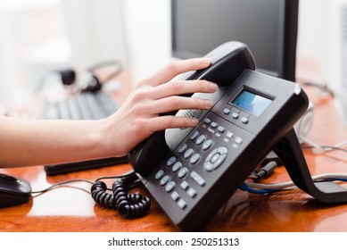 Close Up On Female Hand Holding Phone At Office Desk