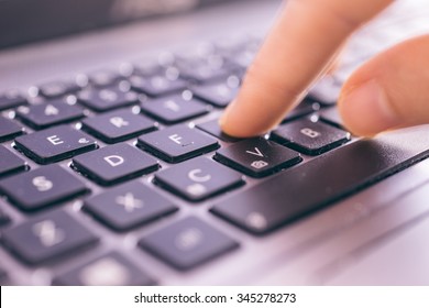 Close up on fingers texting on a computer keyboard - Shutterstock ID 345278273