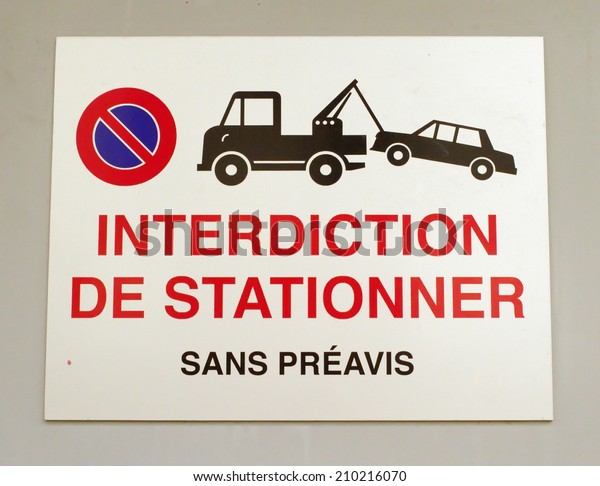 Close up on\
french vehicles towing sign on a\
wall