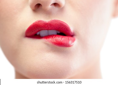 Close up on gorgeous model biting red lips on white background