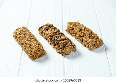 Close up on Granola Bar isolated on white wooden background. Healthy sweet dessert snack. Energy bar of muesli. Granola for breakfast. Copy space - Powered by Shutterstock