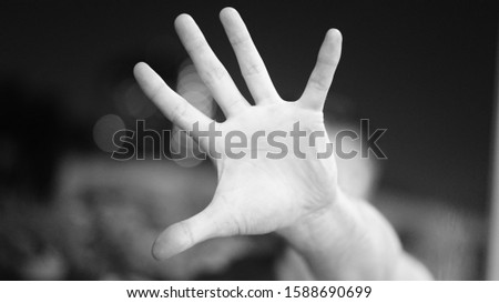 Close up on hand begging for help. Home violence against women, fear and hopelessness. international women's day. BW photo, write your text in the palm of the hand.