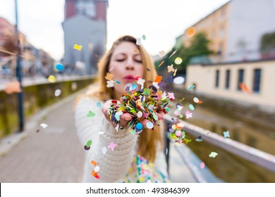 CLose Up On The Hand Of A Caucasian Blonde Woman Blowing Carnival Confetti Hand Hold - Carnival, Party, Colorful Concept