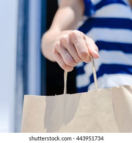 Close Up On Hand Holding A Brown Shopping Paper Bag