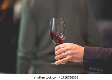 Close Up On A Hand Holding A Glass Of Red Wine