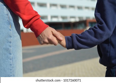 Close Up On Hand On Mother And Child On Sunny Outdoors Background. Happy Assistance, Healthy Motion Togetherness. Human Love, Relation, Protection And Support. Holding Emotional Connection.