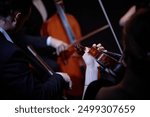 Close up on hand of unrecognizable orchestra musician playing violin in chamber quartet in studio, focus on hand and violin, copy space