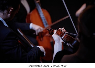 Close up on hand of unrecognizable orchestra musician playing violin in chamber quartet in studio, focus on hand and violin, copy space