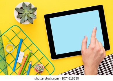 Close up on a hand using digital tablet. View from above.