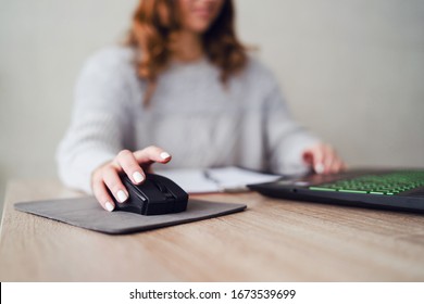 Close Up On Hand Of Young Woman Sitting At Wooden Table In The Office Holding Mouse Of The Laptop Computer Working On The Document Selective Focus In Day