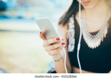 Close Up On The Hand Of Young Woman Holding A Smart Phone, Tapping And Scrolling The Touchscreen - Technology, Social Network, Communication Concept