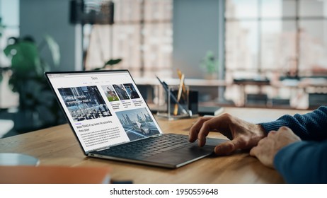 Close up on Hands of Caucasian Man Using Laptop Computer for Reading Latest News. Freelance Male is Doing Financial Market Analysis and Report for Clients and Employer in Cozy Creative Living Room.
