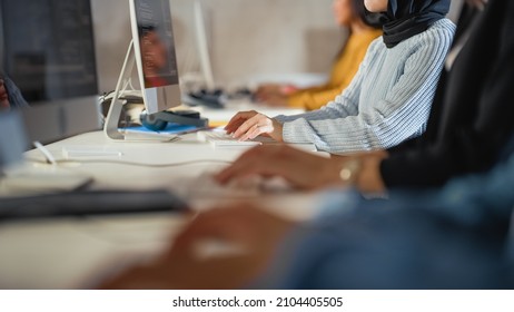 Close Up On Hands Of Diverce Group Of Students Sitting In College Room, Learning Computer Science. Young Scholars Study Information Technology On Computers In University, Writing Code In Class.