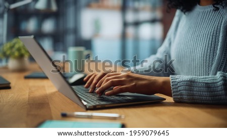 Close Up on Hands of a Female Specialist Working on Laptop Computer at Cozy Home Living Room while Sitting at a Table. Freelancer Woman Chatting Over the Internet on Social Networks.