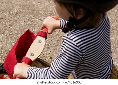 Close up on the hands of the little child on the hanldebar of the bicycle