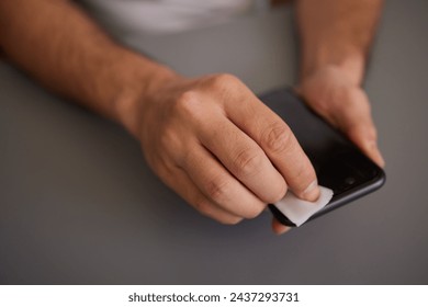 Close up on hands man female holding mobile smart phone in hand wiping cleaning screen - Powered by Shutterstock