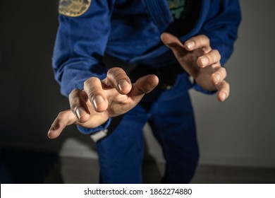 Close up on hands of unknown brazilian jiu jitsu bjj or judo grappler in fighting stance - front view midsection martial arts training concept - Powered by Shutterstock