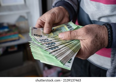 Close Up On Hands Of Unknown Caucasian Senior Man Holding And Counting 100 Euro Banknotes Money Wealth Insurance Payment Or Lifetime Savings Copy Space