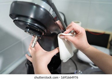 Close Up On Hands Of Unknown Female Caucasian Person Woman Wiping Cleaning Stand Mixer In The Kitchen At Home Disinfection