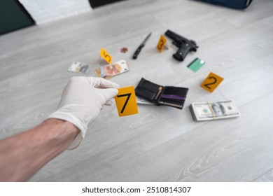 Close up on hands of unknown man forensic police investigator collecting evidence in the plastic bag at the crime scene investigation - Powered by Shutterstock