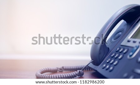 close up on handset telephone answer machine (VOIP system) at operation office desk with copy space for technology communication concept