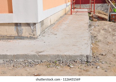 Close Up On House Foundation Waterproofing, Damp Proofing With Concrete Path To Avoid Water Leaks For House Wall.