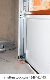 Close Up On Installing Garage Door. Garage Door Post Rail And Spring Installation / Assembly. One Of The Most Important Parts Of Assembly For Garage Door Opener Motorized Device.