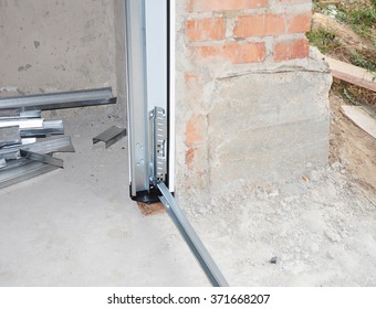 Close Up On Installing Garage Door. Garage Door Post Rail And Spring Installation / Assembly. One Of The Most Important Parts Of Assembly For Garage Door Opener Motorized Device.