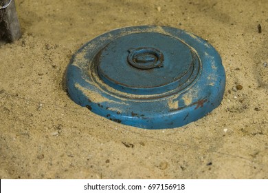 close up on land mine in the sand