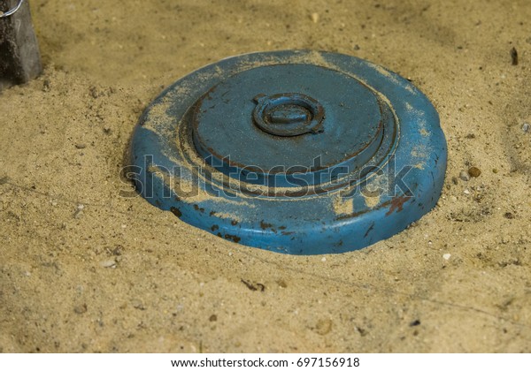 close up on land mine in the\
sand