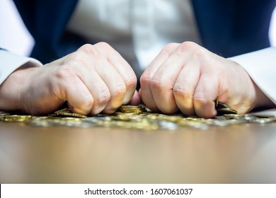 Close Up On Male's Hands Holding Tightly The Coins. Greed Concept.