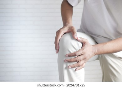 Close Up On Man Suffering Knee Joint Pain With Copy Space 