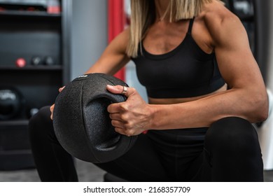 Close Up On Midsection Of Unknown Caucasian Woman Female Athlete Hands Holding Black Medicine Heavy Ball For Training Exercise While Sitting Taking A Brake Copy Space