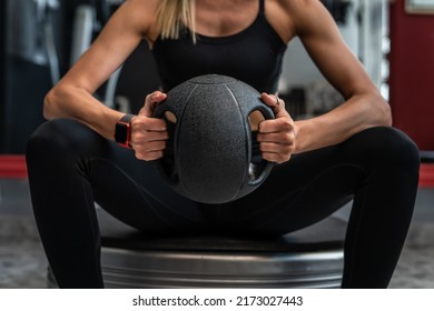 Close Up On Midsection Of Unknown Caucasian Woman Female Athlete Hands Holding Black Medicine Heavy Ball For Training Exercise While Sitting Taking A Brake Copy Space