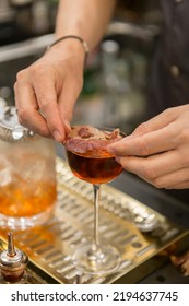 Close Up On A Mixologist Hands Preparing A Cocktail.