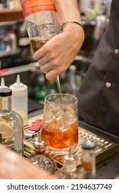 Close Up On A Mixologist Hands Preparing A Cocktail.