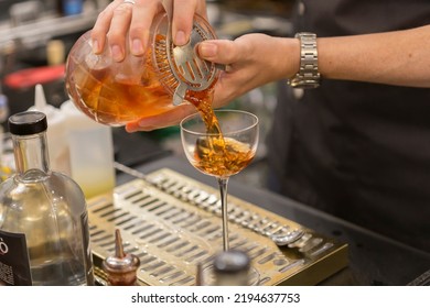 Close Up On A Mixologist Hands Preparing A Cocktail.