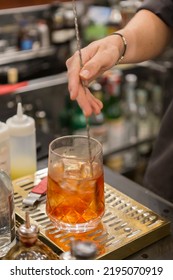 Close Up On A Mixologist Hands Preparing A Cocktail.