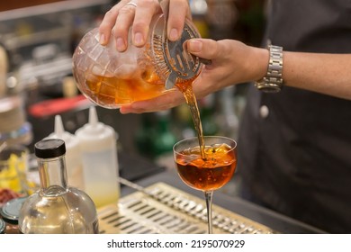 Close Up On A Mixologist Hands Preparing A Cocktail.