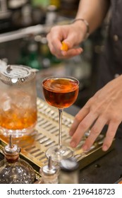 Close Up On A Mixologist Hands Preparing A Cocktail.