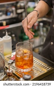 Close Up On A Mixologist Hands Preparing A Cocktail.